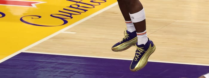 Minnesota Timberwolves guard Anthony Edwards' purple and gold adidas sneakers.